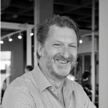 Kevin Rabie Smiling man with short hair and a beard, wearing a checkered shirt ...